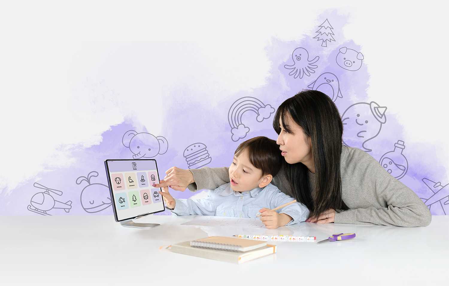 boy with mother drawing on paper